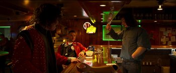 Movie still from “Logan Lucky” (2017), directed by Steven Soderbergh – A group of people sitting at a bar; Medium shot, Low angle