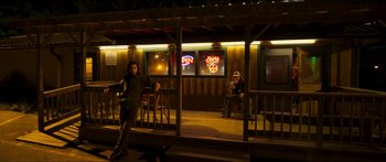 Movie still from “Logan Lucky” (2017), directed by Steven Soderbergh – Two people sitting on a porch at night; Wide shot, Low angle