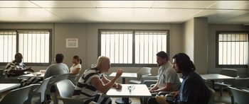 Movie still from “Logan Lucky” (2017), directed by Steven Soderbergh – A group of people sitting at a table eating food; Wide shot, Over the shoulder angle