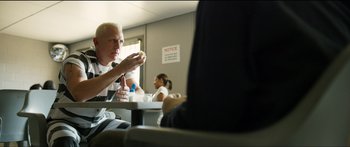 Movie still from “Logan Lucky” (2017), directed by Steven Soderbergh – A group of people sitting at a table eating food; Medium shot, Over the shoulder angle
