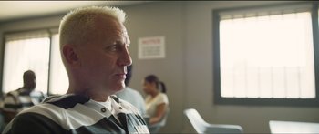 Movie still from “Logan Lucky” (2017), directed by Steven Soderbergh – An older man is sitting in front of a window; Close Up shot, Over the shoulder angle