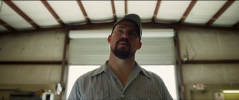 Movie still from “Logan Lucky” (2017), directed by Steven Soderbergh – A person wearing a hat; Close Up shot, Low angle