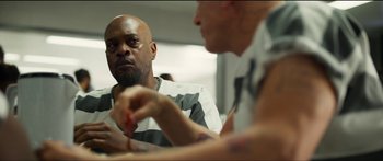 Movie still from “Logan Lucky” (2017), directed by Steven Soderbergh – Two men sitting at a table talking to each other; Medium shot, Over the shoulder angle