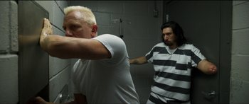 Movie still from “Logan Lucky” (2017), directed by Steven Soderbergh – A man in a jail cell with another man in a jail cell; Medium shot, Over the shoulder angle