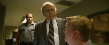 Movie still from “Logan Lucky” (2017), directed by Steven Soderbergh – A man in a suit and tie talking to another man; Close Up shot, Over the shoulder angle