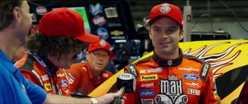 Movie still from “Logan Lucky” (2017), directed by Steven Soderbergh – A group of men standing next to each other in a room; Close Up shot, Over the shoulder angle