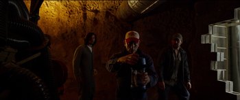 Movie still from “Logan Lucky” (2017), directed by Steven Soderbergh – A man holding a jar in a cave; Medium shot, Low angle