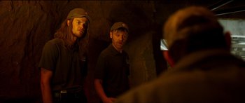 Movie still from “Logan Lucky” (2017), directed by Steven Soderbergh – A couple of men standing next to each other in a room; Medium shot, Low angle
