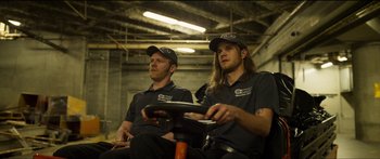 Movie still from “Logan Lucky” (2017), directed by Steven Soderbergh – A couple of men sitting next to each other in a room; Medium shot, Low angle