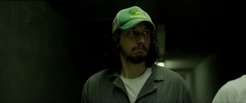 Movie still from “Logan Lucky” (2017), directed by Steven Soderbergh – A person wearing a hat; Close Up shot, Over the shoulder angle