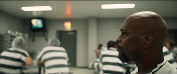 Movie still from “Logan Lucky” (2017), directed by Steven Soderbergh – A man sitting in a jail cell; Close Up shot, Over the shoulder angle