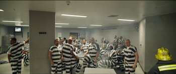 Movie still from “Logan Lucky” (2017), directed by Steven Soderbergh – A large group of men in black and white striped uniforms; Extreme Wide shot, High angle