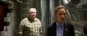 Movie still from “Logan Lucky” (2017), directed by Steven Soderbergh – A man and a woman standing next to each other; Medium shot, Over the shoulder angle