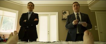 Movie still from “Logan Lucky” (2017), directed by Steven Soderbergh – Two men in suits standing next to each other in front of a mirror; Medium shot, Low angle