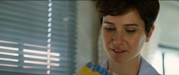 Movie still from “Logan Lucky” (2017), directed by Steven Soderbergh – A person holding a book; Close Up shot, Over the shoulder angle