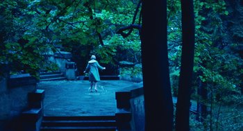 Movie still from “Lore” (2012), directed by Cate Shortland – A woman is walking down the stairs in the dark; Extreme Wide shot, High angle