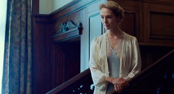 Movie still from “Lore” (2012), directed by Cate Shortland – A woman standing in front of a wooden wall; Medium shot, Low angle