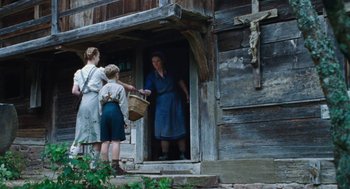 Movie still from “Lore” (2012), directed by Cate Shortland – Two women and a boy standing in front of an old house; Wide shot, Low angle