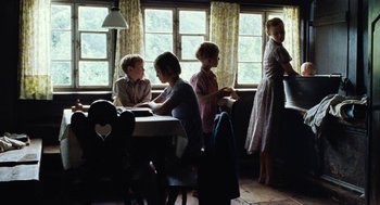Movie still from “Lore” (2012), directed by Cate Shortland – A group of children sitting at a table in front of a window; Wide shot, Low angle