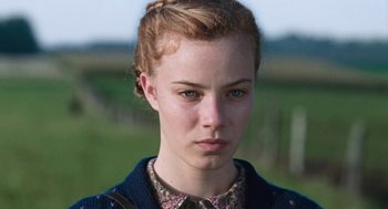 Movie still from “Lore” (2012), directed by Cate Shortland – A young woman with red hair wearing a sweater; Close Up shot, Low angle