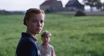 Movie still from “Lore” (2012), directed by Cate Shortland – A young girl and a young boy standing in a field; Close Up shot, Over the shoulder angle