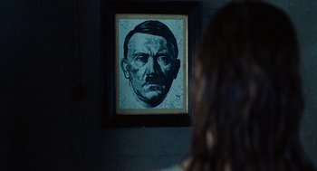 Movie still from “Lore” (2012), directed by Cate Shortland – A painting of adolf hitler is displayed on a wall; Close Up shot, Low angle