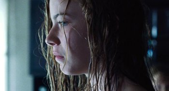 Movie still from “Lore” (2012), directed by Cate Shortland – A person's face with long dreadlocks; Close Up shot, Over the shoulder angle