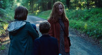 Movie still from “Lore” (2012), directed by Cate Shortland – A group of people walking down a dirt road; Medium shot, Over the shoulder angle