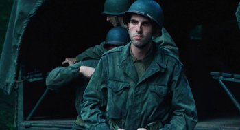Movie still from “Lore” (2012), directed by Cate Shortland – A man in a green uniform with a helmet on; Medium shot, Low angle