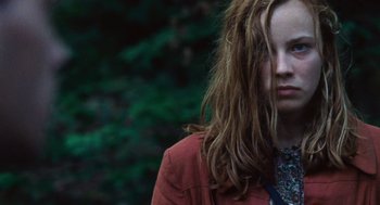 Movie still from “Lore” (2012), directed by Cate Shortland – A woman with long brown hair wearing a red jacket; Close Up shot, Over the shoulder angle
