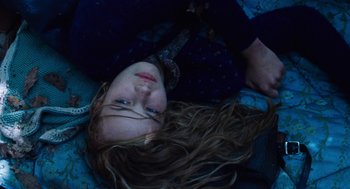 Movie still from “Lore” (2012), directed by Cate Shortland – A woman laying on the ground with her hair hanging down; Close Up shot, Overhead angle