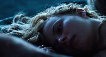 Movie still from “Lore” (2012), directed by Cate Shortland – A woman laying in bed with her head on her hand; Close Up shot, Overhead angle