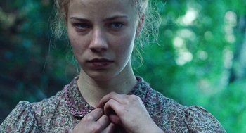 Movie still from “Lore” (2012), directed by Cate Shortland – A young woman holding her hands around her neck; Close Up shot, Low angle