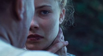 Movie still from “Lore” (2012), directed by Cate Shortland – A woman's face with her hand on her neck; Extreme Close Up shot, Over the shoulder angle