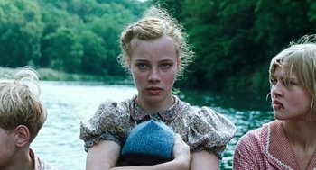 Movie still from “Lore” (2012), directed by Cate Shortland – A young girl with a hat in her hands; Close Up shot, Low angle