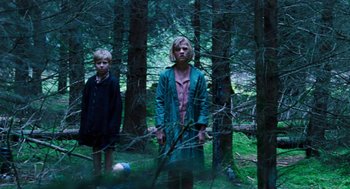 Movie still from “Lore” (2012), directed by Cate Shortland – Two people standing next to each other in the woods; Wide shot, Low angle