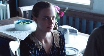 Movie still from “Lore” (2012), directed by Cate Shortland – A woman sitting at a table with a plate of food; Close Up shot, Over the shoulder angle