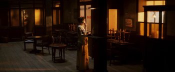 Movie still from “Leap Year” (2010), directed by Anand Tucker – A woman standing in front of a laptop computer; Wide shot, High angle