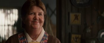 Movie still from “Leap Year” (2010), directed by Anand Tucker – An older woman smiles for the camera; Close Up shot, Over the shoulder angle