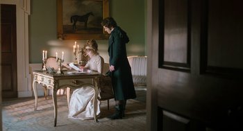 Movie still from “Love & Friendship” (2016), directed by Whit Stillman – A man and a woman sitting at a dining room table; Wide shot, Over the shoulder angle