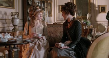 Movie still from “Love & Friendship” (2016), directed by Whit Stillman – Two women sitting on a couch talking to each other; Medium shot, Over the shoulder angle