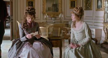 Movie still from “Love & Friendship” (2016), directed by Whit Stillman – Two women dressed in period clothing sitting in a room; Medium shot, Over the shoulder angle
