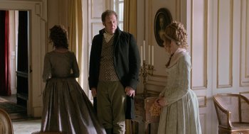 Movie still from “Love & Friendship” (2016), directed by Whit Stillman – A man and two women standing next to each other in a room; Medium shot, Over the shoulder angle