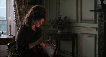 Movie still from “Love & Friendship” (2016), directed by Whit Stillman – A woman is reading a book in a dark room; Medium shot, High angle