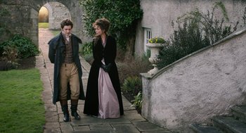 Movie still from “Love & Friendship” (2016), directed by Whit Stillman – A man and a woman walking down a sidewalk; Wide shot, High angle