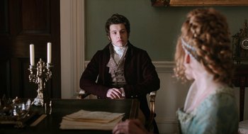 Movie still from “Love & Friendship” (2016), directed by Whit Stillman – A man sitting at a table in front of a woman; Medium shot, Over the shoulder angle