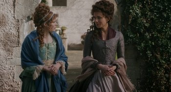 Movie still from “Love & Friendship” (2016), directed by Whit Stillman – Two women dressed in medieval clothing talking to each other; Medium shot, Over the shoulder angle