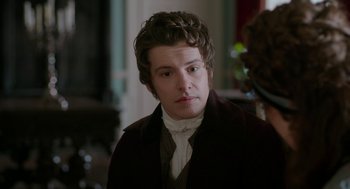 Movie still from “Love & Friendship” (2016), directed by Whit Stillman – A young man in a suit and tie; Close Up shot, Over the shoulder angle