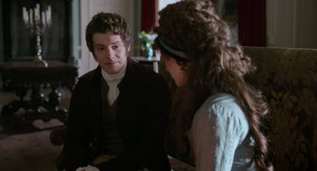 Movie still from “Love & Friendship” (2016), directed by Whit Stillman – A man and a woman sitting in front of each other; Medium shot, Over the shoulder angle