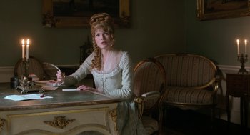 Movie still from “Love & Friendship” (2016), directed by Whit Stillman – A woman sitting at a table writing on a piece of paper; Medium shot, High angle